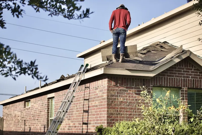 Professional roofer working on a residential roof in Playland Village